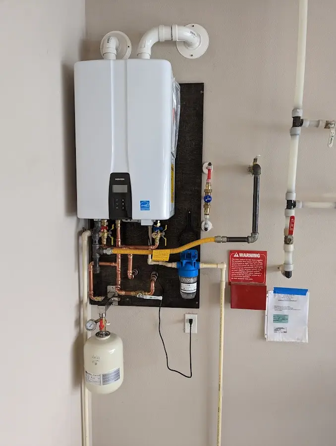 Professional plumber installing copper piping in a Southfield home